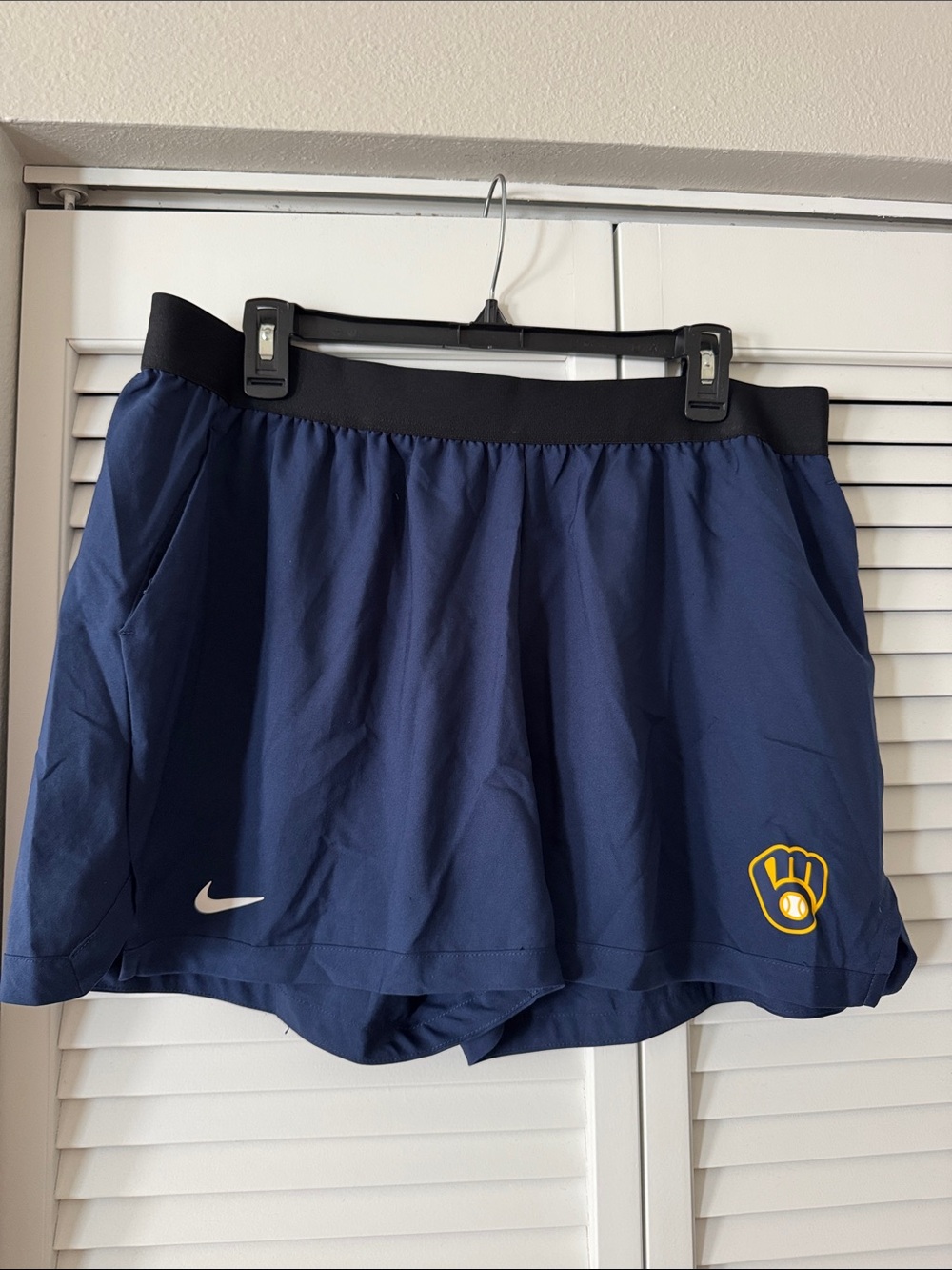 Nike Women's Navy Blue Athletic Skort with Black Waistband and Yellow Logo